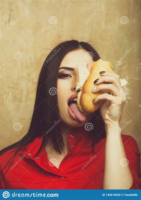 Hungry Pretty Brunette Woman Eats Big Sandwich Or Burger Stock Photo