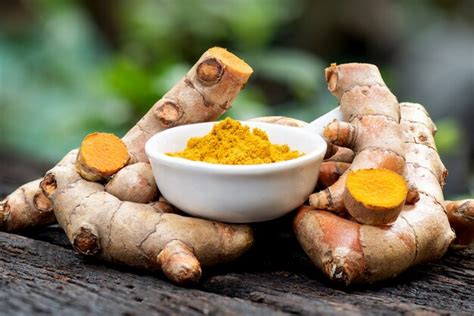 Premium Photo Turmeric Rhizome And Powder On Nature