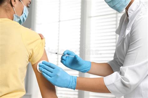 Doctor Giving Injection To Patient In Hospital Closeup Vaccination