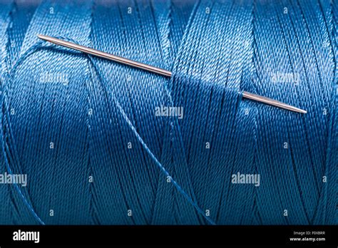Sewing Needle In Blue Thread Bobbin Close Up Stock Photo Alamy