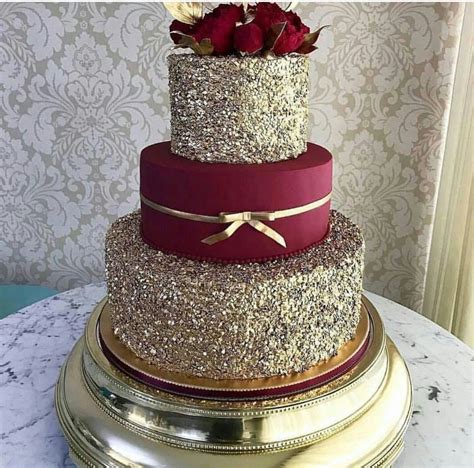 Cut gold fondant out to resemble icing dripping down the cake sides. Burgundy and gold cake for wedding #goldweddingcakes ...