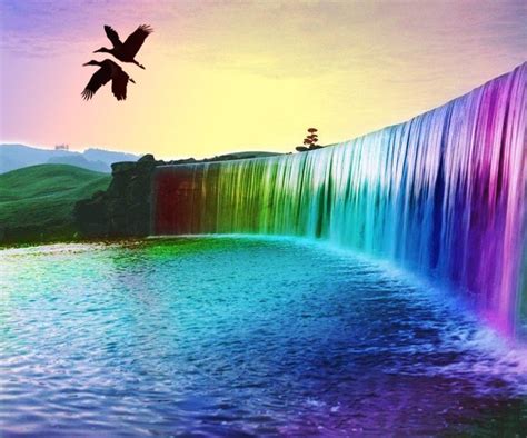 A Bird Flying Over A Rainbow Waterfall In The Sky