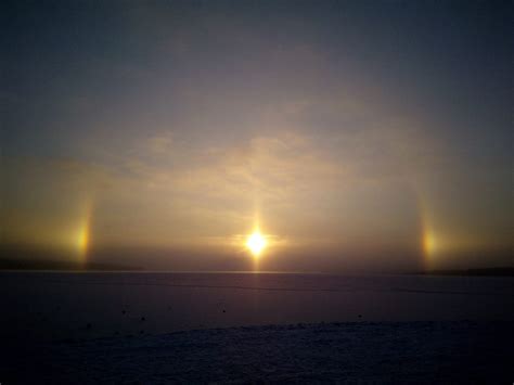 Light up the sky, i feel, is a combination of the two. Three suns phenomenon lights up the sky of Murmansk in ...
