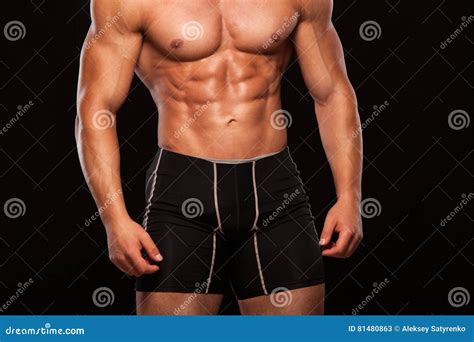 Strong Athletic Man Fitness Model Torso Showing Six Pack Abs Isolated On Black Background With