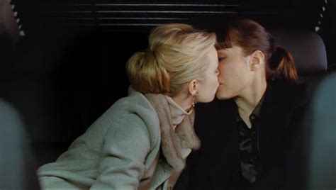 rachel mcadams and noomi rapace get a little closer in a scene from the trailer for brian de