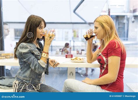 friends in bar two girls drinking in restaurant stock image image of light drink 61690887