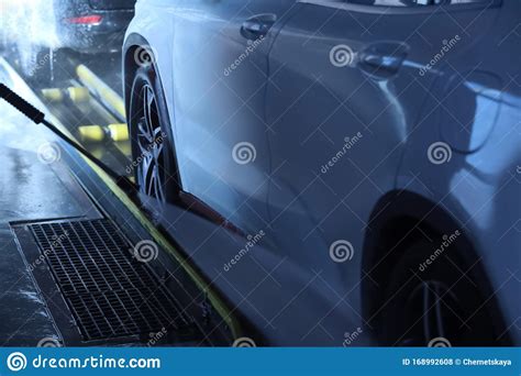 Cleaning Auto With High Pressure Water Jet At Wash Stock Photo Image