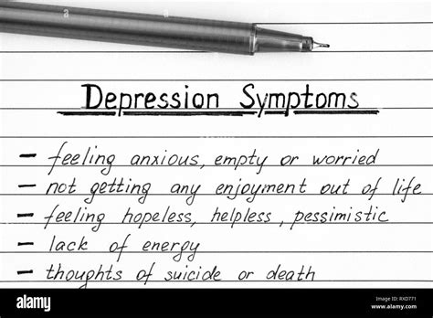 Depression Symptoms Writing On The List With Pen Close Up Stock Photo