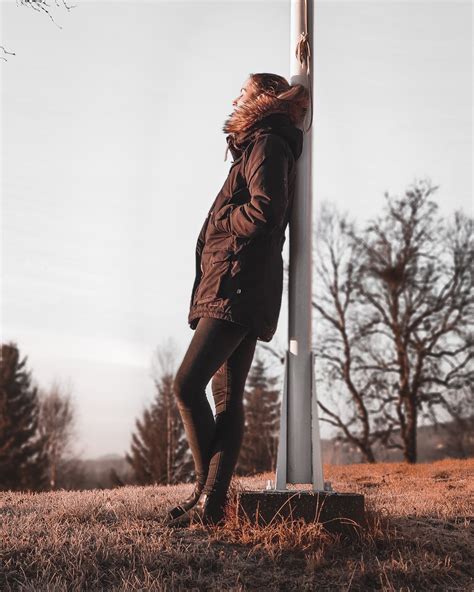 Person Leaning Backwards On White Pole · Free Stock Photo
