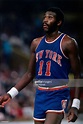 Bob McAdoo of the New York Knicks walks on the court against the...