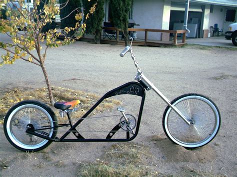 A Black And Silver Bike Parked In Front Of A House