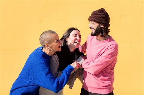 Premium Photo Group Of Three Friends Laughing And Joking Around