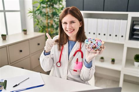 Young Doctor Woman Holding Sweets Candy Smiling Happy And Positive