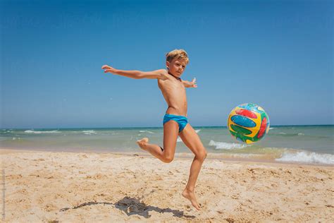 Boy Playing With Ball At The Beach By Dejan Ristovski