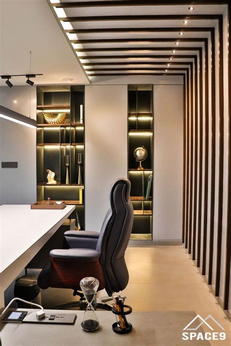 An Office Space With Black And White Striped Walls Leather Chairs And