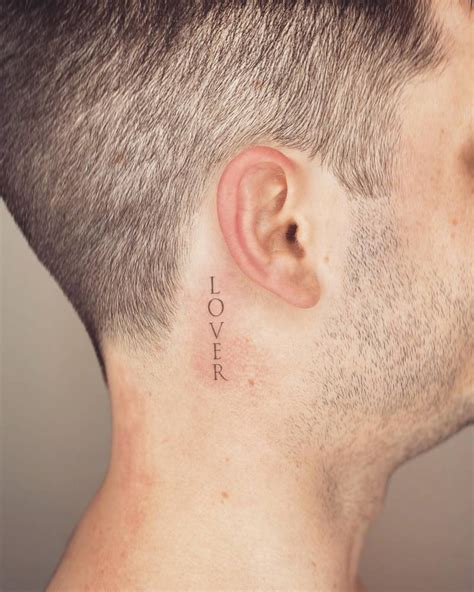 Tattoo Of The Word Lover Done Behind The Ear
