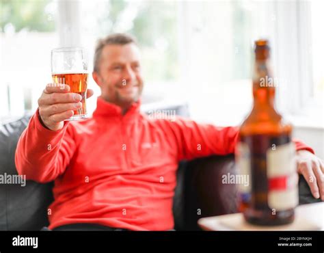 Cheers Close Up Of Isolated Smiling Man Relaxing At Home Drinking Beer