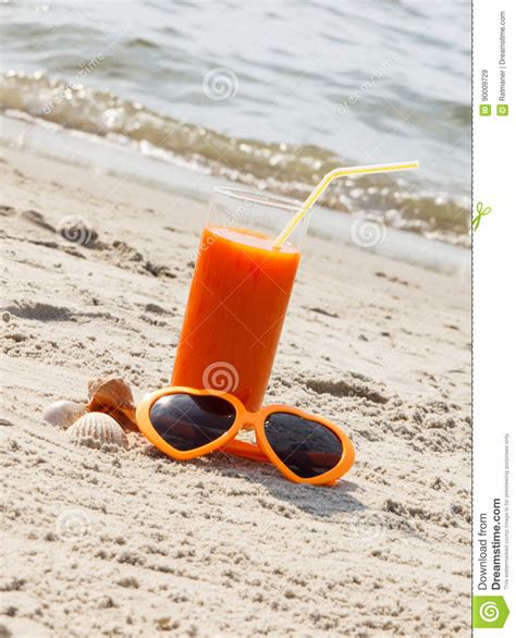 Carrot Juice And Sunglasses At Beach Concept Of Vitamin A And Beautiful Lasting Tan Stock