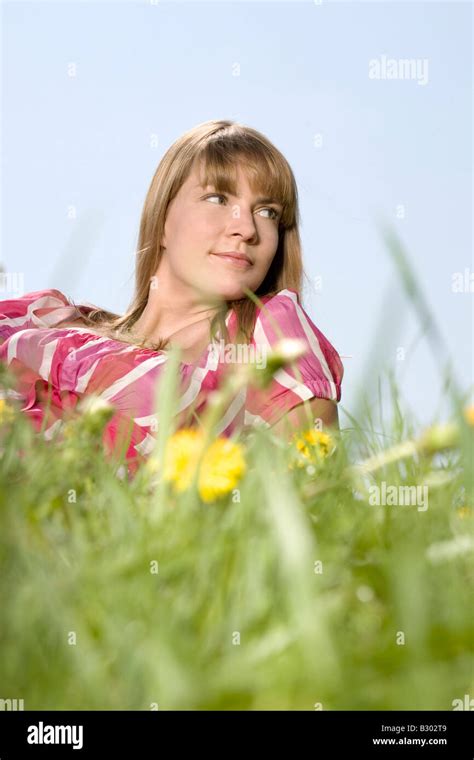 Woman Lying Down In Meadow Stock Photo Alamy
