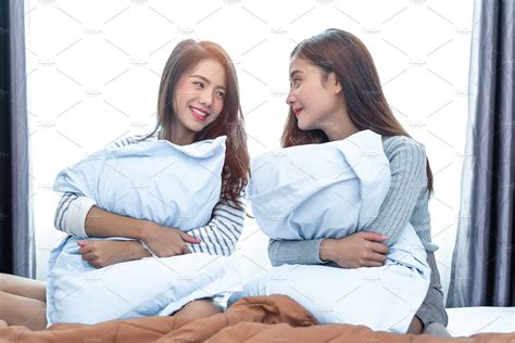 two asian lesbian women looking together in bedroom couple peop people images ~ creative market