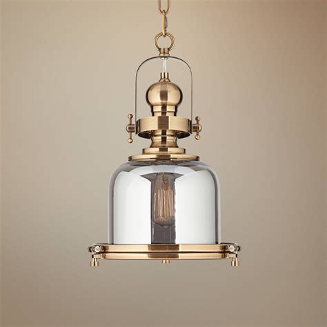 A Light Fixture With A Glass Dome Hanging From It S Side On A Beige Background