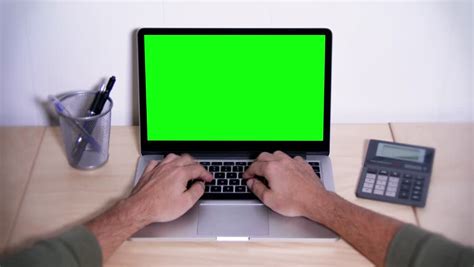 Download desktop computer stock photos. A Man Types On A Laptop On His Desk. Green Screen For Your ...