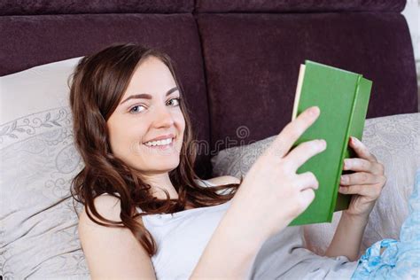 Woman Lying In Bed While Reading A Book Stock Image Image Of House Bedding 68114497