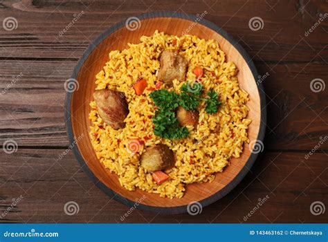 Plate With Rice Pilaf And Meat On Wooden Background Stock Photo Image
