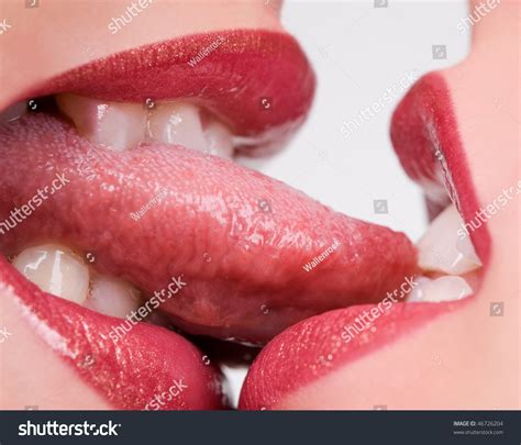Beautiful Female Lovers Kissing With Tongues Out Stock Photo