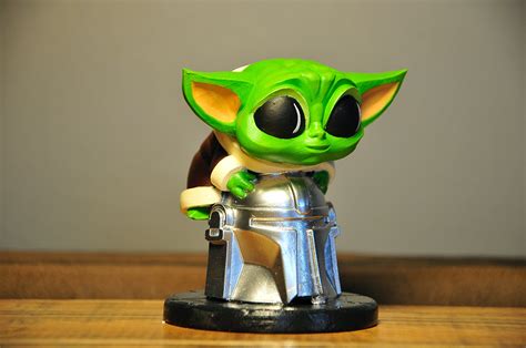 Baby Yoda Sitting On Mandalorian Helmet Tabletop Figure Etsy Ireland