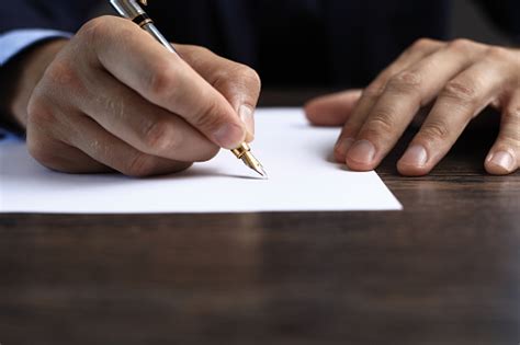 Man Signing A Document Or Writing Correspondence Stock Photo Download