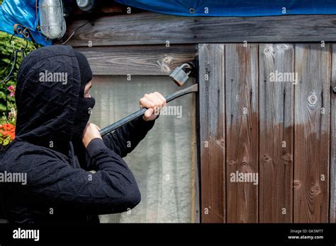 Burglar breaking and entering Stock Photo - Alamy
