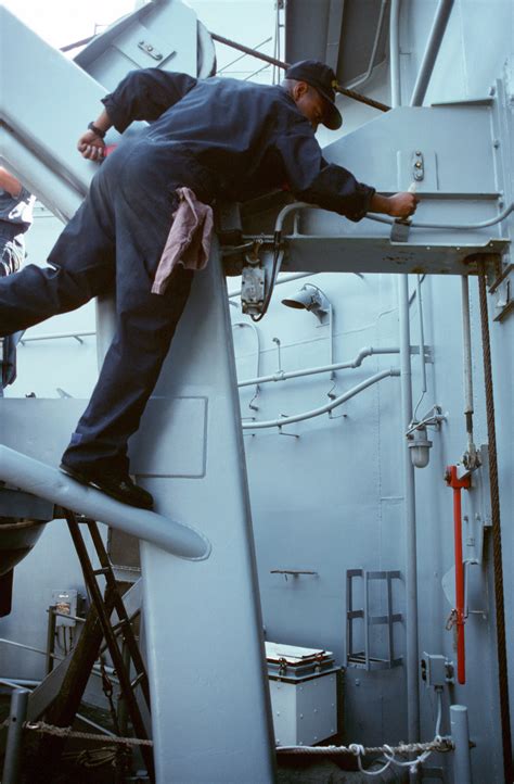 A Sailor Paints A Beam Aboard The Guided Missile Destroyer Uss