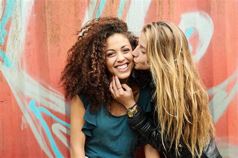 Girl Kissing Her Friend By Stocksy Contributor Guille Faingold