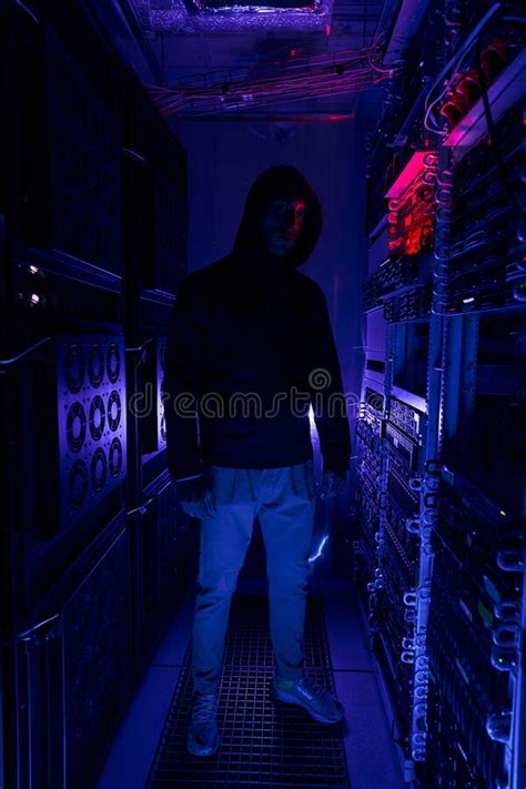 Male Hacker In Hoodie Among Server Racks Stock Photo Image Of Data
