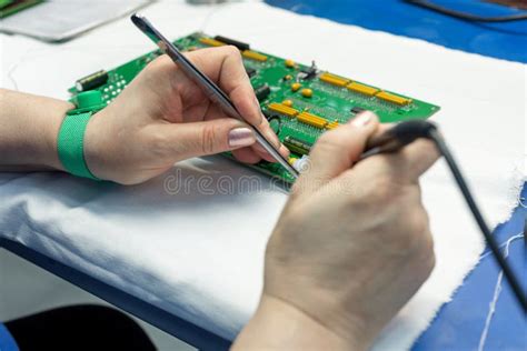The Process Of Assembling An Electronic Module The Worker S Hands