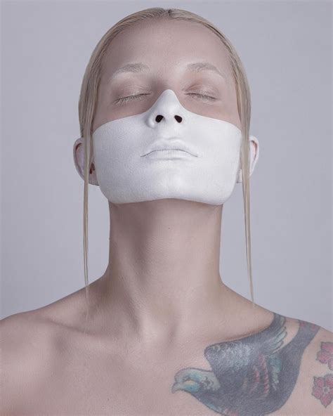 A Woman With Her Face Covered In White Mask