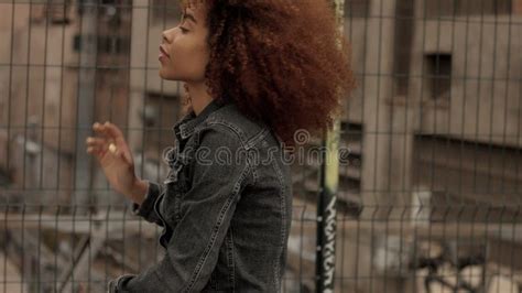 Black Mixed Race Woman With Big Afro Curly Hair In Outdoor City Stock