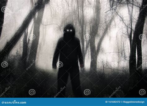 A Horror Concept A Silhouetted Hooded Figure Standing In A Winter