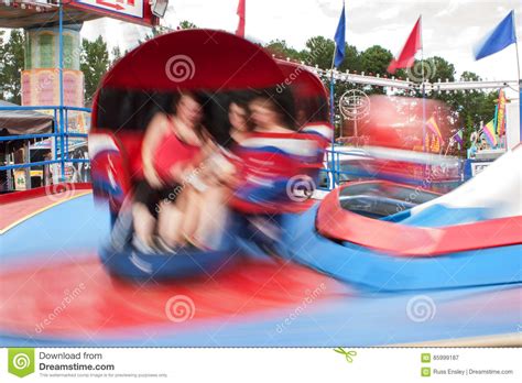 motion blur of people on fast moving carnival ride editorial photo 85999187