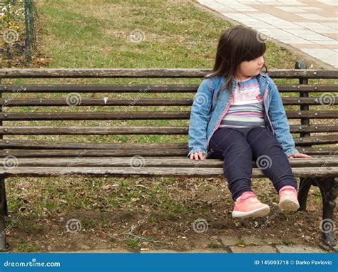 A Little Girl Sitting On A Park Bench Stock Photography Cartoondealer