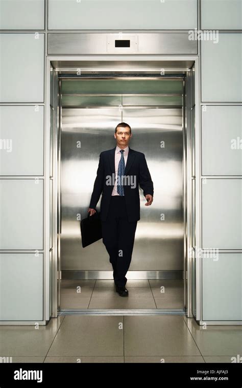 Businessman Exiting Elevator Front View Stock Photo Alamy