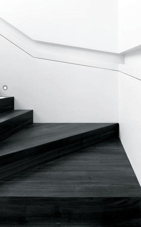 Minimal Stained Black Wide Wooden Staircase With A Recessed Handrail