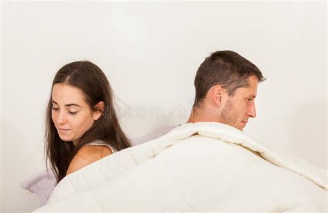 Young Angry Couple Not Talking To Each Other In Bed With Problems Stock