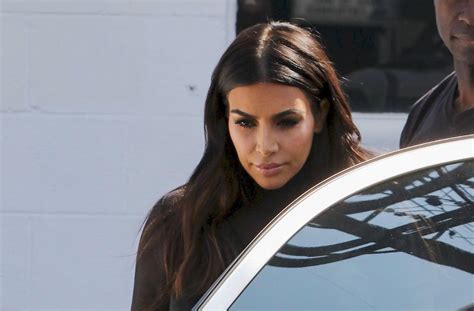 Kim Kardashian Shows Off Her Bra In Sheer Black Top