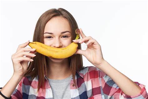 Teen Girl Holding Banana Like A Smile In Front Of Her Lips Stock Image