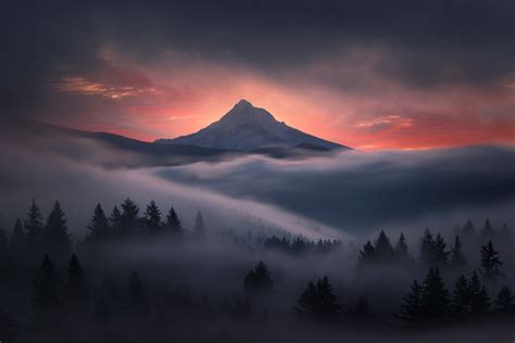 Sun Setting Behind Snowy Winter Mountain