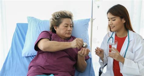 The Doctor Is Asking And Explaining The Illness And Giving The Medicine With Old Women Patients