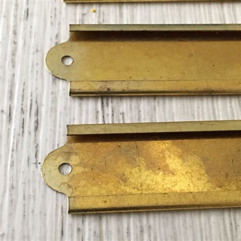 Creating file cabinet labels by writing a category title on each label. Vintage Brass Label Holders File Drawer Name Plates