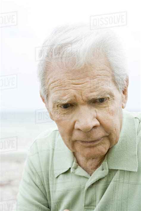 Senior Man Looking Down Furrowing Brow Close Up Stock Photo Dissolve
